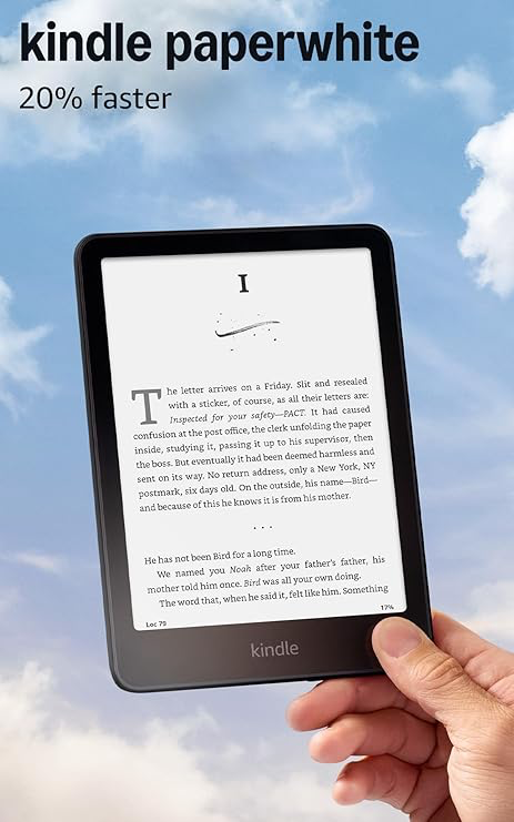 Black 12th-generation Kindle Paperwhite held in front of a sky background.